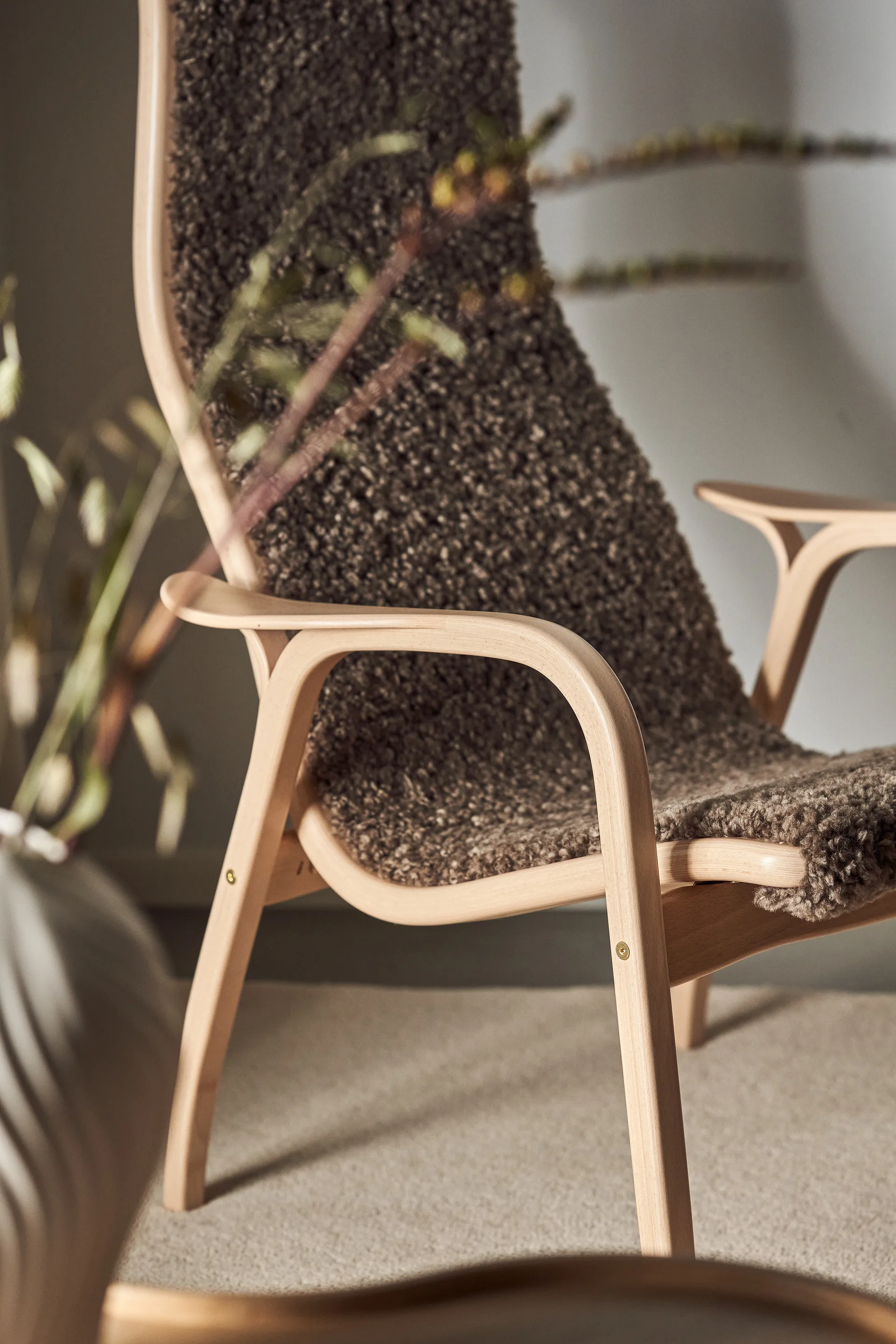Lamino armchair and footstool varnished beech/sheepskin, Sahara (nougat-brown) Swedese