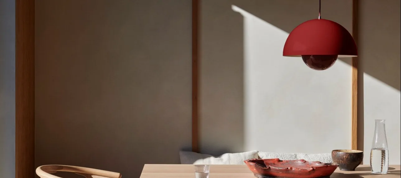 Modern lighting ideas to put the finishing touch on your home. Here you see the VP1 pendant lamp from &Tradtion in a deep red hanging over a dining table.