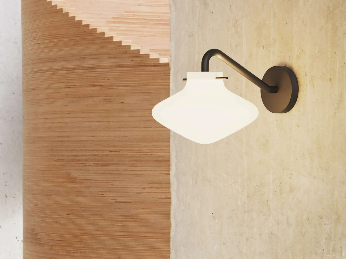 A wall-mounted light fixture with a white, rounded glass shade on a concrete wall, next to a curved wooden structure.